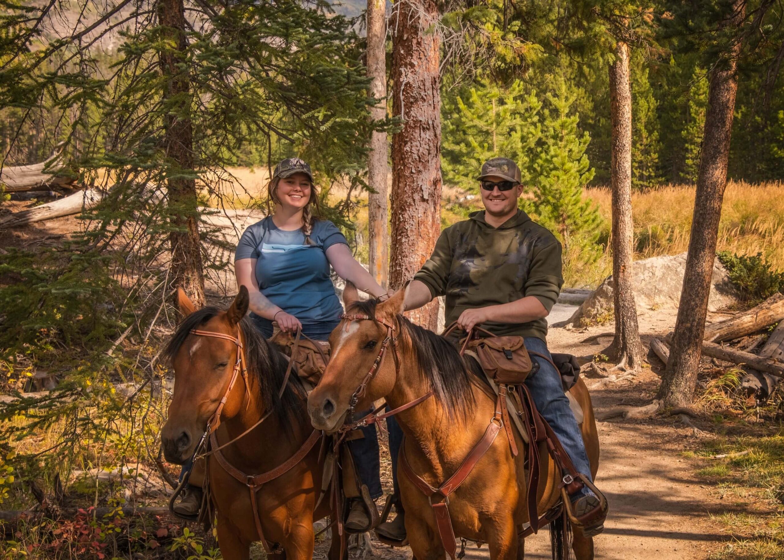 A woman and a man Horseback Riding in Aspen, Colorado.