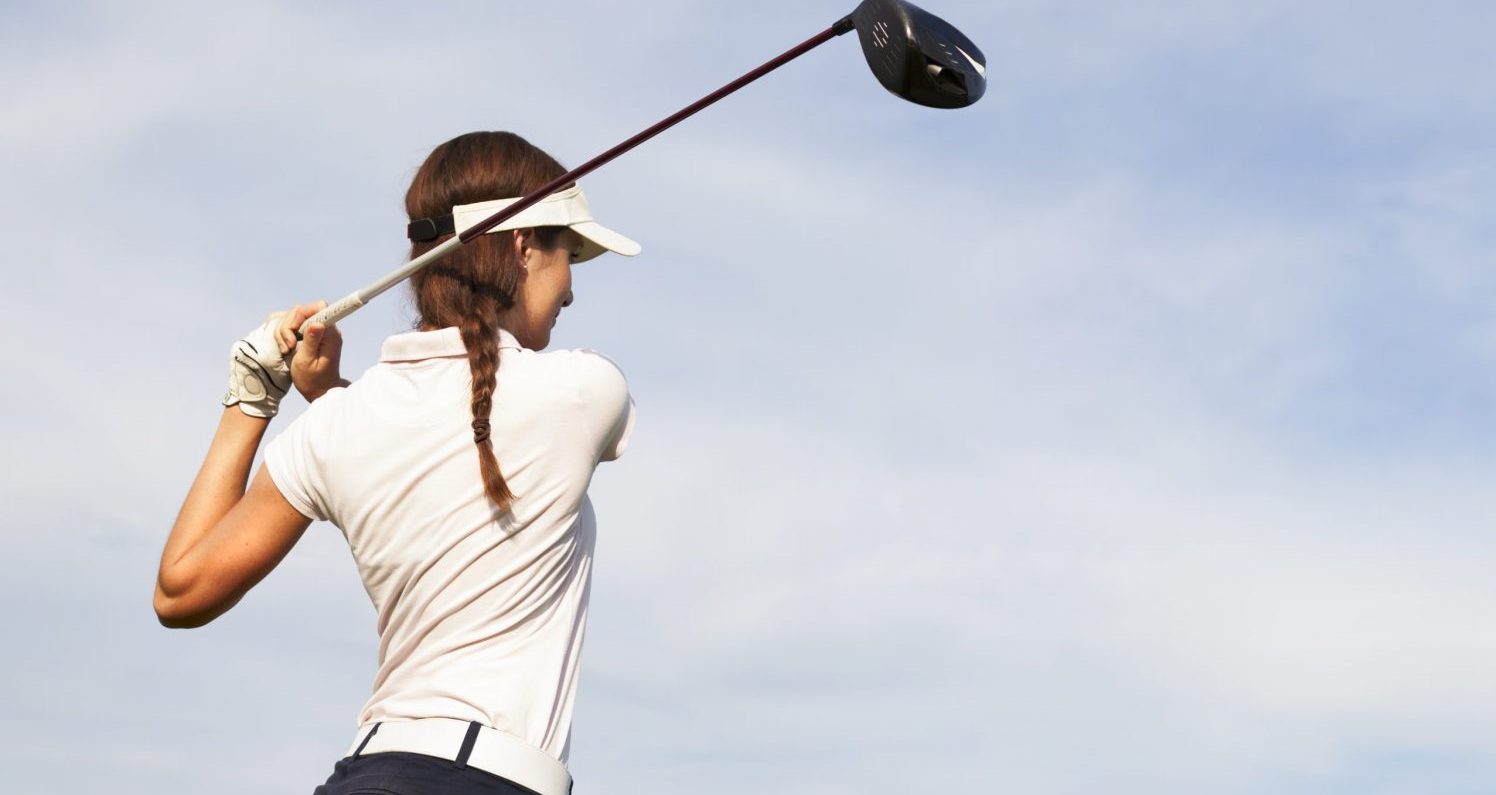 Woman swinging a golf club at Aspen Golf Clubs